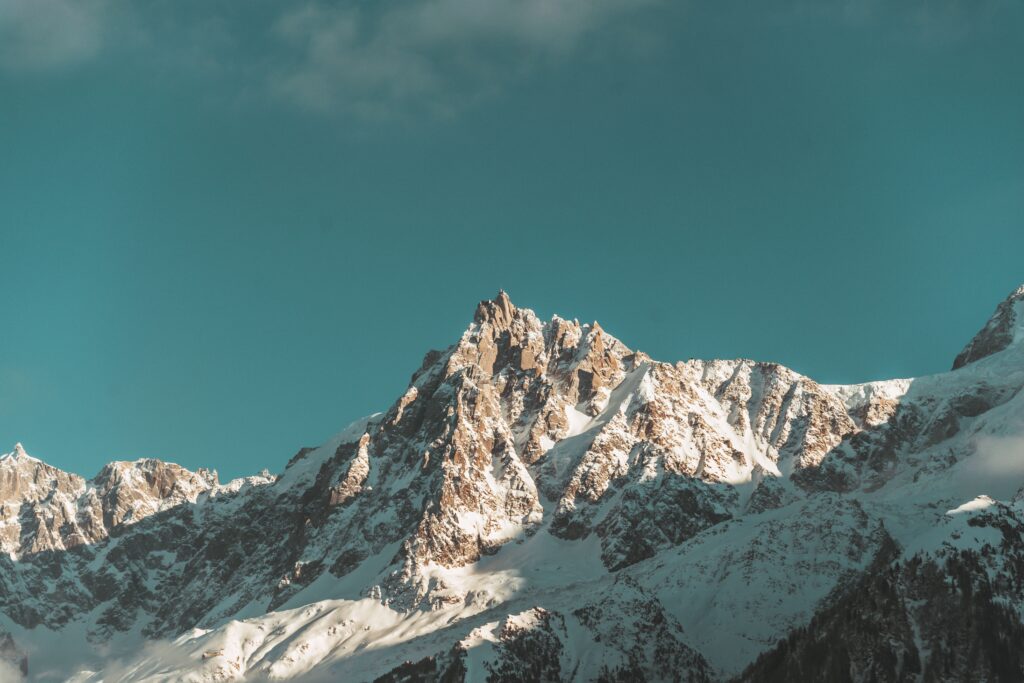 Scenic view of the snowcapped peaks of the French Alps with a vivid blue sky backdrop.