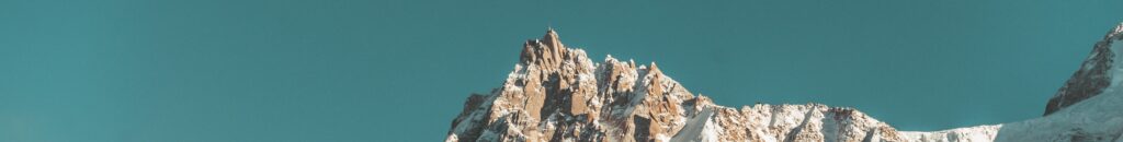 Scenic view of the snowcapped peaks of the French Alps with a vivid blue sky backdrop.